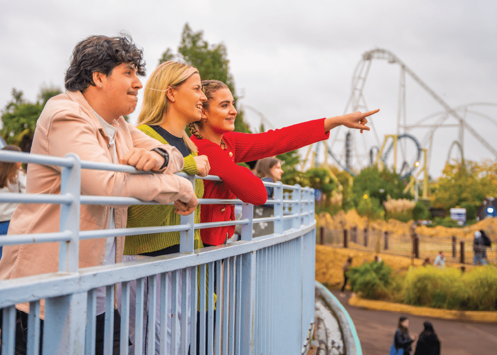 3 guests stood on a balcony looking over towards the Thorpe Park